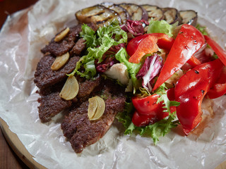 Slices of roast beef with garlic and red pepper.