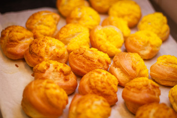 Delicious eclairs. Bakery in the oven. Confectionery. Yellow small ecriles
