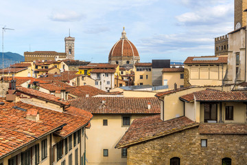 Fototapeta premium Old City - A rooftop view of the historical Old Town of Florence, with Giotto's Campanile and Brunelleschi's Dome of the Florence Cathedral rising high at center. Florence, Tuscany, Italy.