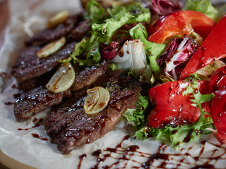 Slices of roast beef with garlic and red pepper.