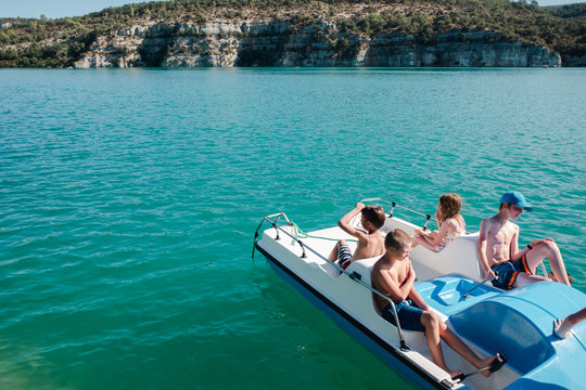 group of kids relaxing on a pedal boat