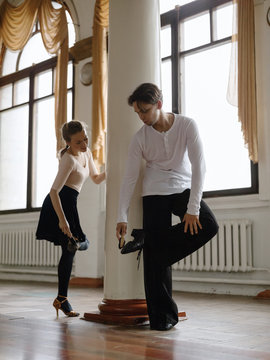 Dance partners preparing shoes soles