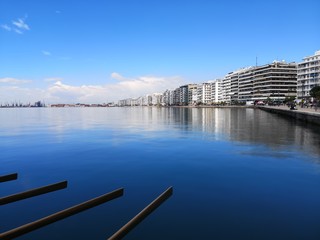 Fototapeta na wymiar Thessaloniki / greece 11 april 2019 : long exposure shot of the brach of thessaloniki ,the port the buildings and the sun is making the day perfect after so much rain last week,