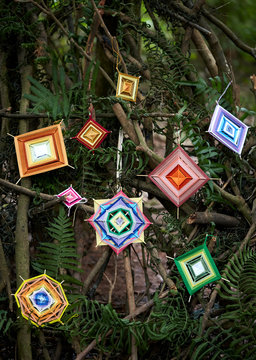 Hand-woven dream catcher graphic, in a natural wood environment.
