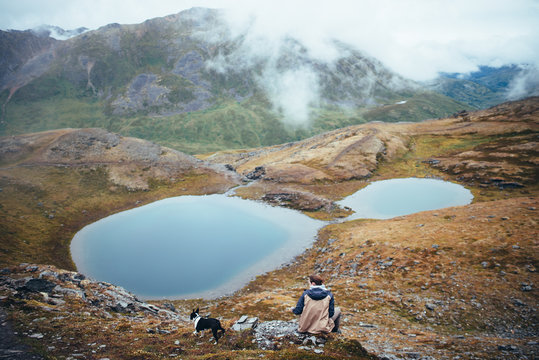Man and Dog in Front of Alpine Lake