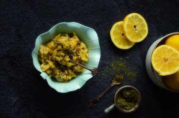 Green pumpkin salad with rice,lemon and mint on dark background. Vegetarian food 