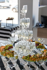 Wedding slide champagne for bride and groom indoors.