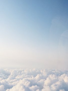 Sea of clouds from window of airplane