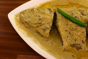 Closeup of cooked hilsa fish in mustard gravy