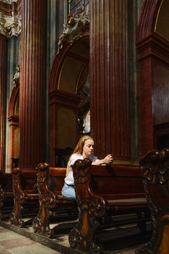 Woman praying in cathedral