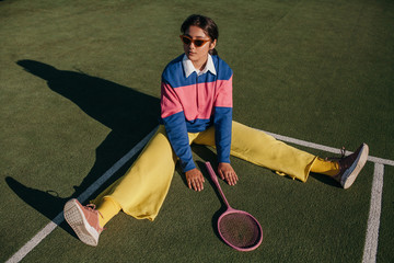 Stylish asian female with tennis racket