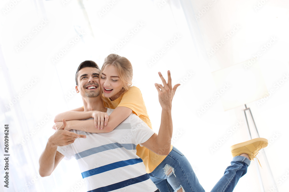 Wall mural cute young couple dancing indoors