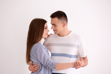 Young couple dancing together against white background