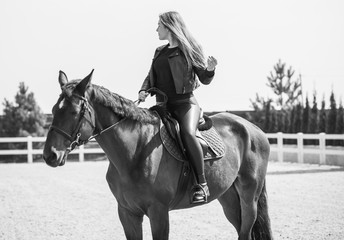 Woman on a horse at rancho. Horse riding, hobby time. Concept of animals and human 