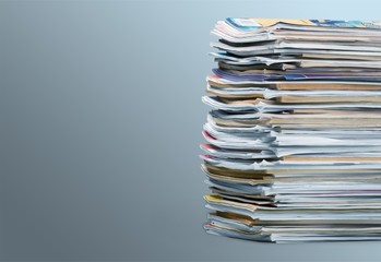 Pile of newspapers on white background