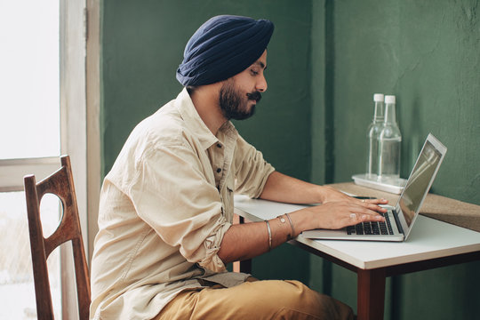 Indian Man Working on Laptop