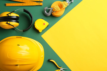 Flat lay composition with construction tools on color background, space for text