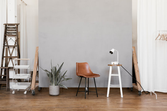 photo studio props set up in front of cement grey backdrop wall
