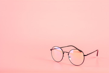 Eyeglasses on pink background.