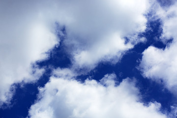 Big white fluffy clouds in the blue sky.Summer background.