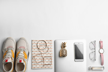 Flat lay composition with laptop, sneakers, accessories and space for text on white background. Fashion blogger