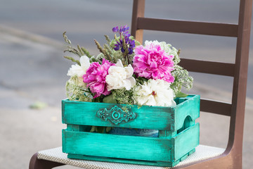 green vintage wooden box with pink, white, crimson flowers