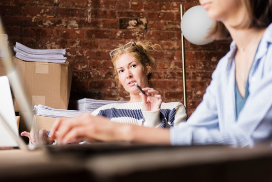 Woman talking to co-workers