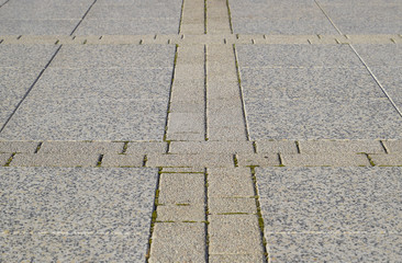 Figure out the paving slabs in the square. Background of paving slabs. Texture of stone products