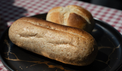 toasted bread placed in black plate,isolated on red patterned napkin