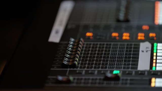 4K footage of sound engineer pressing the keys, moving the buttons. Mixing console in sound recording studio. RED camera