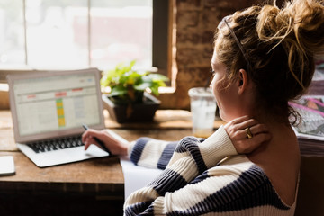 Close up of woman working on laptop computer at office