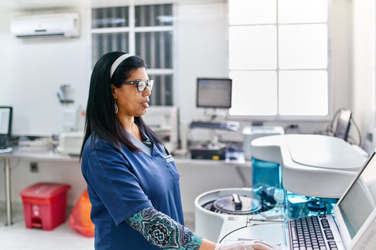 Technician at medical analyzer machine