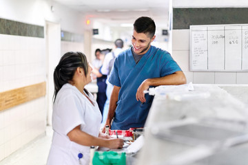 Male and female hospital workers enjoying working together