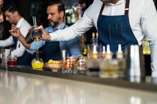Professional team of young bartenders working
