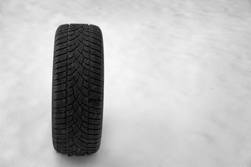 New winter tire on fresh snow. Space for text