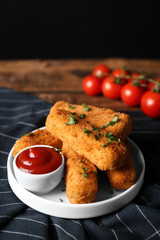 Plate of cheese sticks and sauce on table, closeup