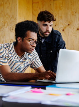 Two men working together in a modern office.