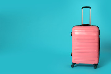 Stylish suitcase on color background. Space for text