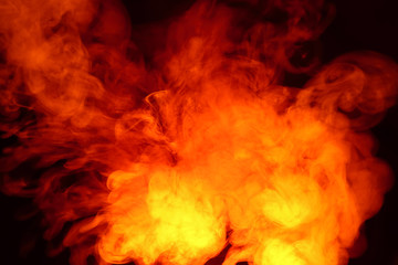 Imitation of bright flashes of orange-red flame. Background of abstract colored smoke.
