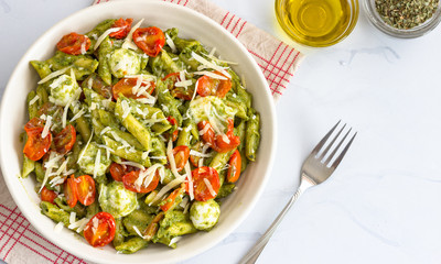 Vegetable Basil Pesto Pasta High Angle Photo on White Background. Italian Food, Italian Cuisine, Veg Pasta Concept.
