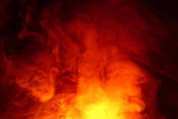 Fototapeta premium Imitation of bright flashes of orange-red flame. Background of abstract colored smoke.