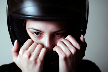 Female biker with helmet, dangerous sport
