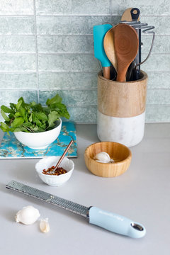 Grater with garlic on kitchen counter