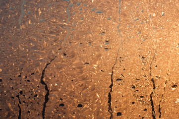 Abstract background with place for text. Drops on glass, orange and yellow bokeh