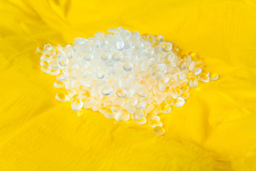 Transparent Polyethylene granules on plastic polyethylene film . HDPE.Plastic pellets. Plastic Raw...