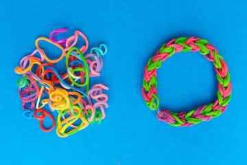 Chaos and order. Rubber bands for weaving loose and bracelet of rubber bands