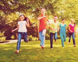 Fototapeta premium Happy children running and playing in garden on sunny day