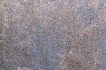Fragment of a concrete wall with cracks as background preparation.
