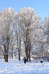 Kid playing in the snow cold weather