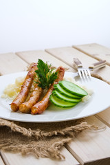Fried sausage with mashed potato and fresh cucumber